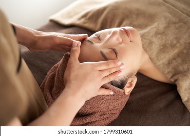 Japanese Woman Receiving A Facial Massage At An Aesthetic Salon