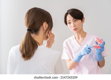 Japanese woman showing a model and talking - Powered by Shutterstock