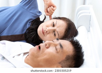 Japanese woman suffering from snoring - Powered by Shutterstock