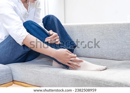 Japanese woman touching her feet