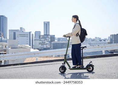 A Japanese woman traveling on an electric scooter - Powered by Shutterstock