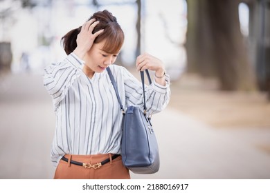 A Japanese Woman Who Is In A Hurry To Forget Something And Is Likely To Be Late