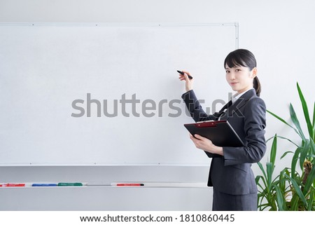 Japanese woman writing on a whiteboard