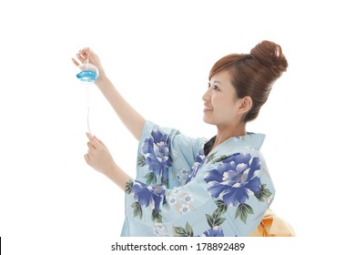 Japanese Woman In Yukata To Attempt To Install A Wind Chime