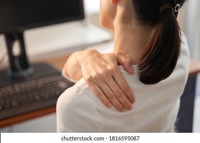 Japanese women businesswoman whose shoulders hurt from working from home - Shutterstock ID 1816595087