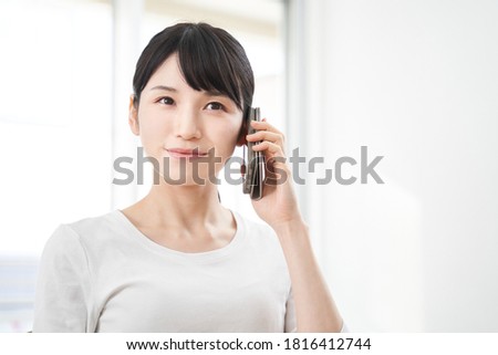 Japanese women making calls on their smart phones
