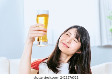 Japanese women with a smile in their 20s and 30s who look at the glass to enjoy a glass from noon on holidays in their rooms - Powered by Shutterstock