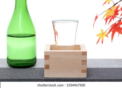 Japanese wooden box masu with sake on table, on white background  - Powered by Shutterstock