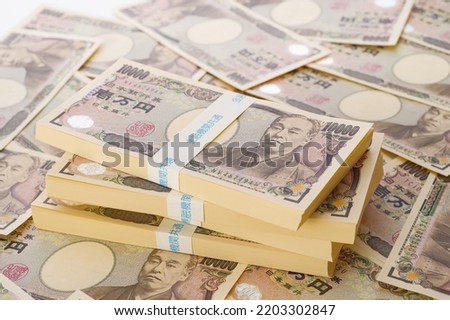 A lot of Japanese yen. 10,000 yen bills and a bundle of bills. The banknotes are written as 