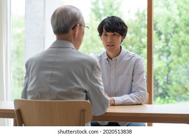 Japanese young man and father spending time indoors - Powered by Shutterstock