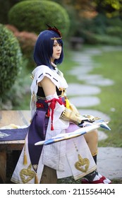 Japanese Young Woman Hunter Cosplay With Bow On Japanese Garden