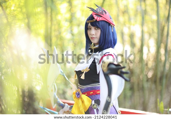 Japanese young woman hunter cosplay with bow on\
Japanese garden