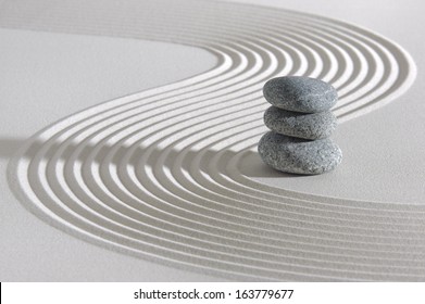 Japanese ZEN garden with stacked stones in raked sand - Powered by Shutterstock