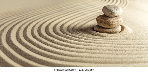 Japanese zen garden with stone in raked sand - Shutterstock ID 1167257569