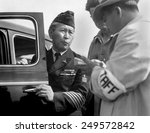 Japanese-American veteran, dressed in his WW2 uniform, reports for his WW2 internment. Santa Anita Park assembly, Arcadia, California, April 5, 1942. Photo by Dorothea Lange.