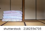 Japanese-style room and folded futon. Futon is Japanese bedding.