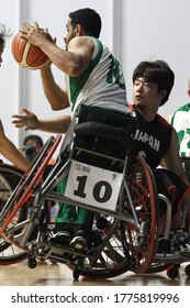 Japan's Rin Kawahara (R) Fight For A Ball With Saudi Arabia's Musa Alzahrani (L) During The Men's Wheelchair Basketball Competition Of The 2018 Asian Para Games In Jakarta On October 7, 2018