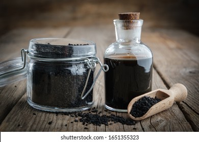 Jar Of Black Cumin Or Roman Coriander Seeds And Black Caraway Oil Bottle. Ingredients For Cooking. Ayurveda Natural Treatments.