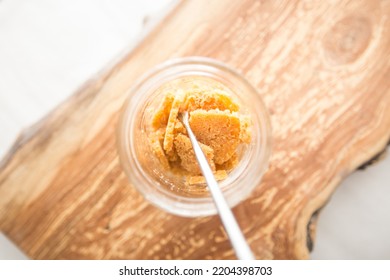 Jar Of Cannabis Live Resin On A Wooden Board