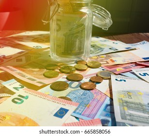 A jar of cash on the table.under jar a lot of dollars, cash, money, concept of accumulation, Finance, business, Economics.