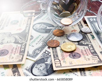 A jar of cash on the table.under jar a lot of dollars, cash, money, concept of accumulation, Finance, business, Economics.