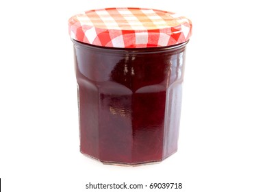 Jar with cherry jam isolated on white background.
