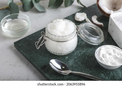 Jar Of Coconut Body Scrub And Ingredients On Light Background