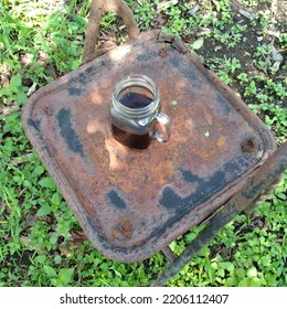 A Jar Of Coffee On An Old Metal Chair Outdoor At The Park 