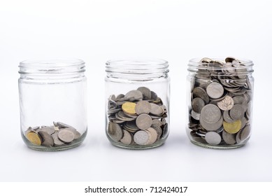 Jar Of Coins And Money In White Background