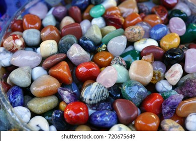 Jar of colorful polished stones and rocks - Shutterstock ID 720675649