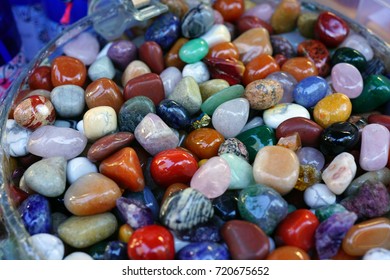 Jar of colorful polished stones and rocks - Shutterstock ID 720675652