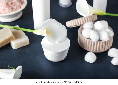 Jar Of Cosmetic Product, Cotton Balls, Soap And Calla Lily On Dark Background