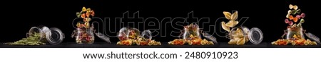 Jar of different type of pasta isolated on black background.