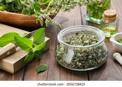 Jar of dried mint leaves. Fresh peppermint leaves on a cutting board. Blossom Mentha piperita medicinal plants, bottles of mint essential oil and infusion. Alternative herbal medicine. Aromatherapy.