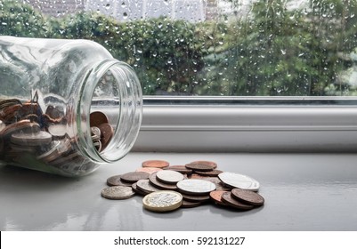 Jar Of English Money With Rainy Day Background