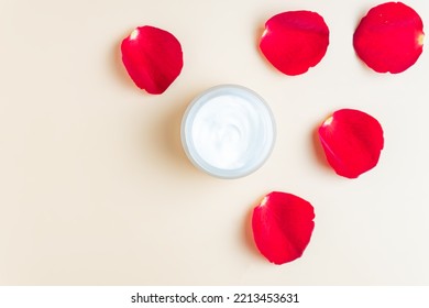 A jar of face or eye skin care cream with rose petals. The concept of natural cosmetics from natural incredients, purity and tenderness. Copy space, mockup