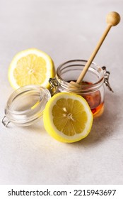 Jar With Farm Honey And Fresh Lemon Gray Background Vertical