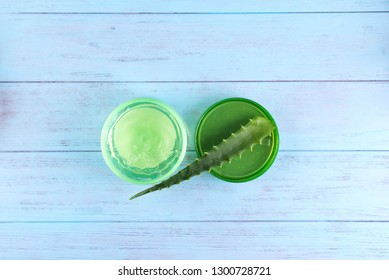 A Jar Of Fresh Aloe Vera Gel On Blue Wooden Background. Aloe Vera Is Natural Remedy For Sunburn Relief And Cure Many Things