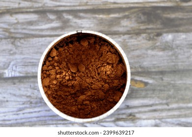 A jar of grind coffee of the Coffea plant and the source for coffee. It is the pip inside the red or purple fruit often referred to as a coffee cherry or stone fruit, Turkish coffee, selective focus