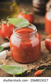 Jar Of Home Made Classic Tomato Sauce On Wooden Table Close Up