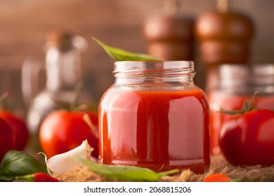 Jar Of Home Made Classic Tomato Sauce On Wooden Table Close Up