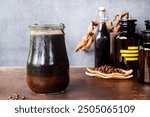 a jar of homemade cold brew coffee, ground coffee soaked in cold water, how to make cold brew coffee at home.