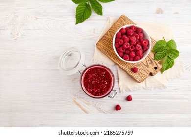 A jar of homemade raspberry jam and a bowl with fresh raspberries  - Powered by Shutterstock