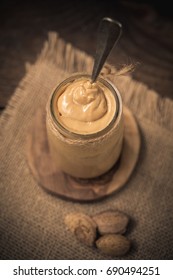 A Jar Of Homemade Raw Organic Almond Butter With A Fresh Salty Almond