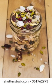 Jar Of Homemade Trail Mix On Wood