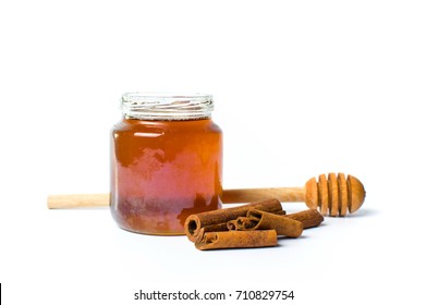 Jar Of Honey And Cinnamon Isolated On White