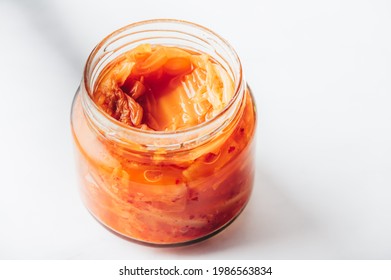 Jar of Korean Kimchi, fermented cabbage with radish, garlic, onion and red chilli pepper powder. Traditional Korean side dish also great in stir fries and stews. Natural, vegan friendly, gluten free