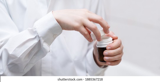 Jar With A Lid In The Hands Of A Child