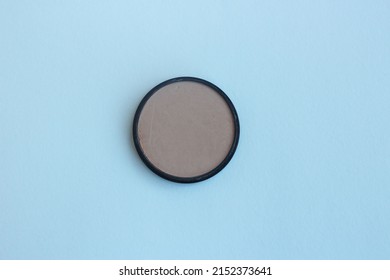 A Jar With Light Brown Powder On A White Background. View From Above. Beauty And Cosmetics.