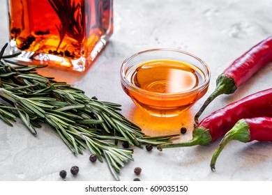 Jar With Oil And Chili On Stone Table Background